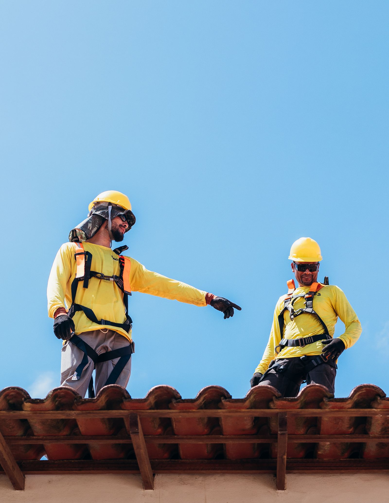 Two Northgate roofers securing a tile roof ridge