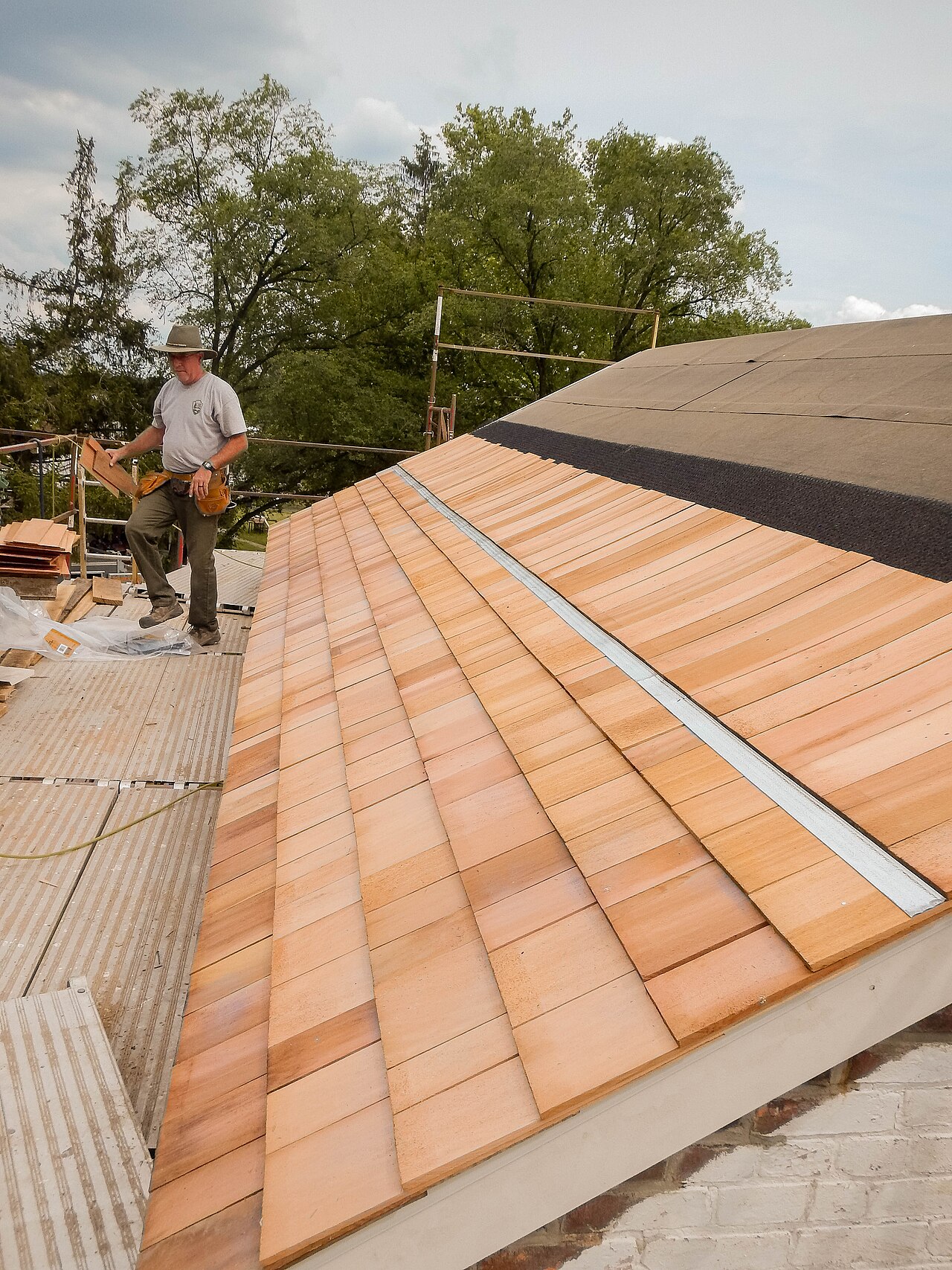Craftsman laying cedar shingles on a Northgate project